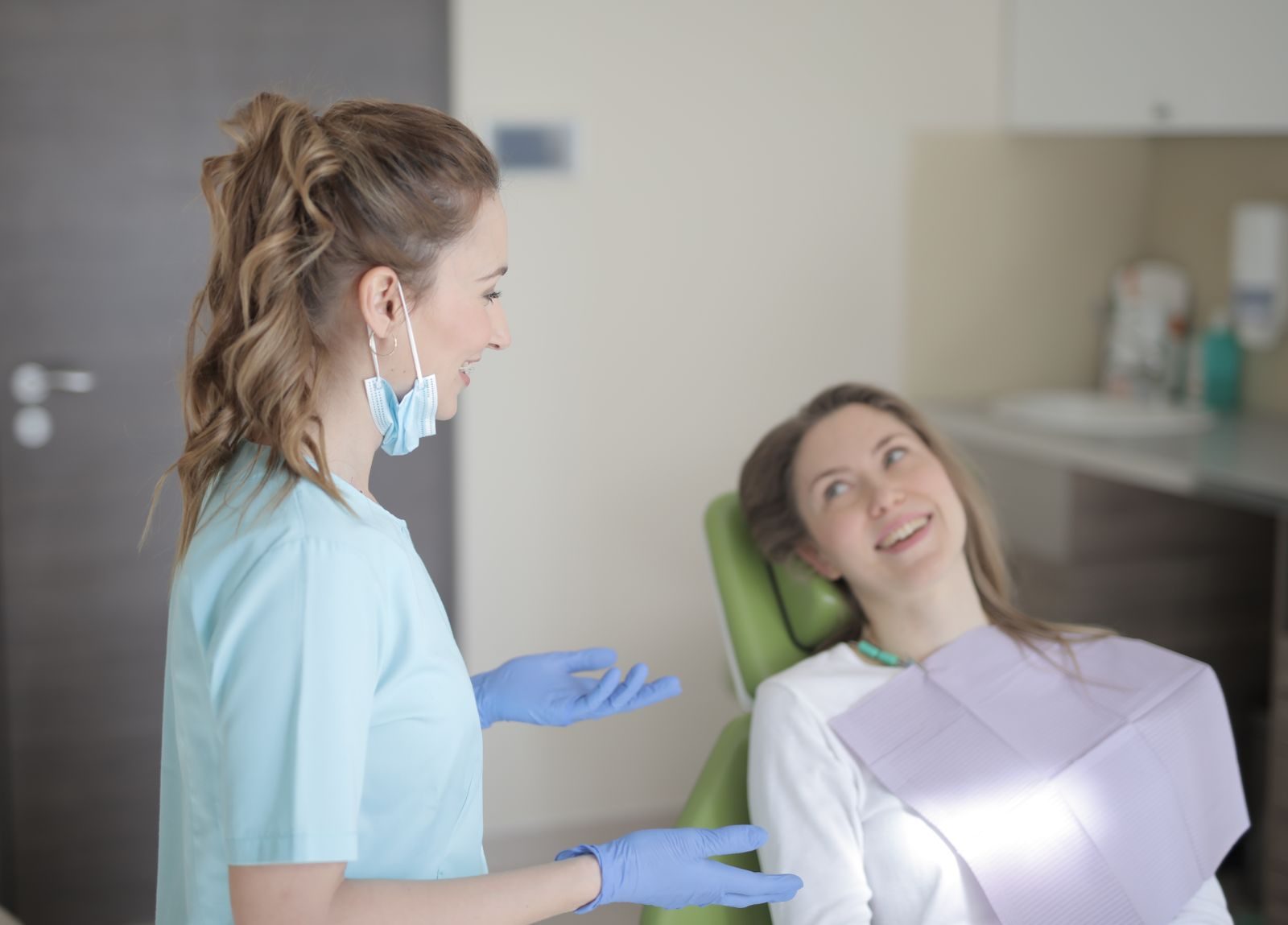 Dentist speaking with a patient before treatment