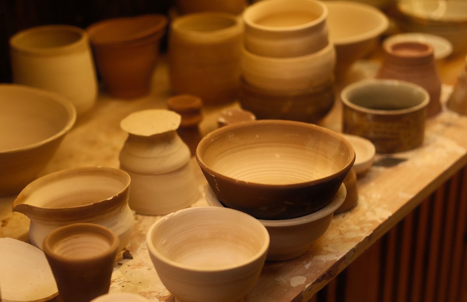 Handcrafted ceramic bowls arranged in an artisan studio.