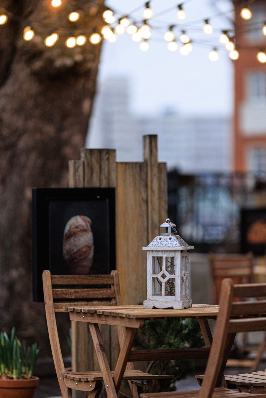 Decorative lantern on a warm outdoor patio table.