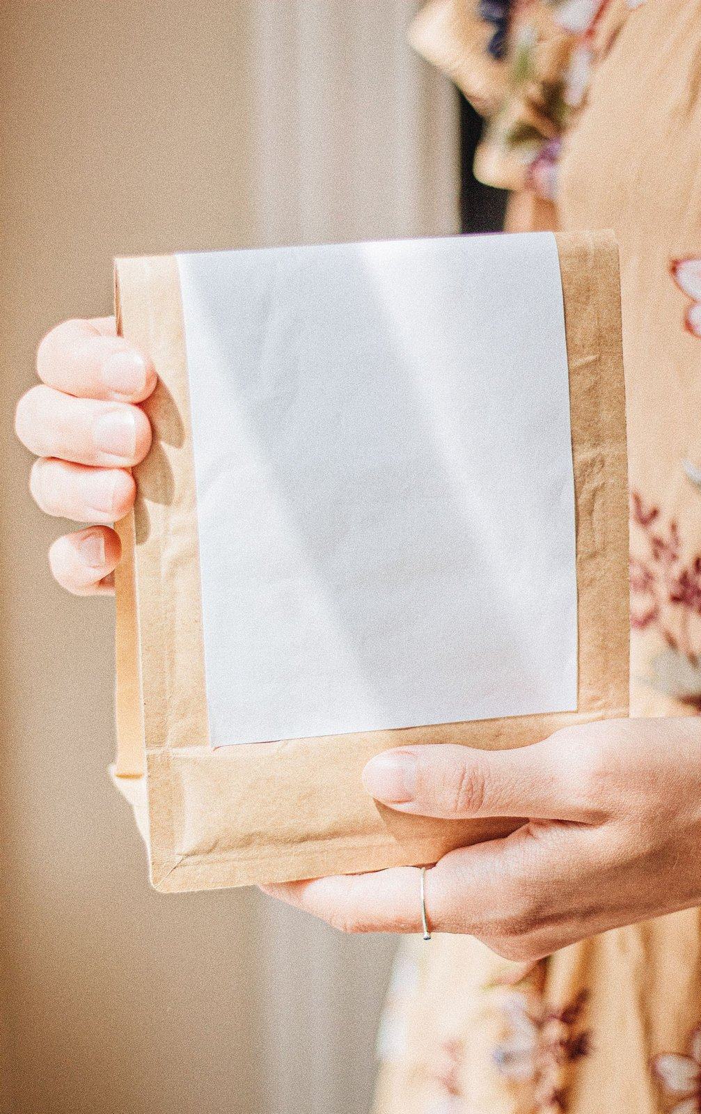 Paper coffee bag held in warm natural light